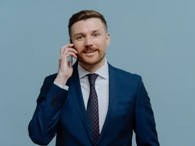 happy-businessman-enjoying-conversation-on-mobile-WEBP-e1741564672453.webp